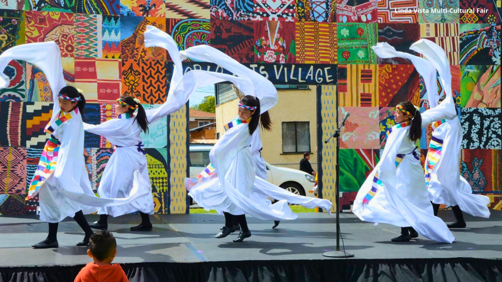 performers wearing white on stage