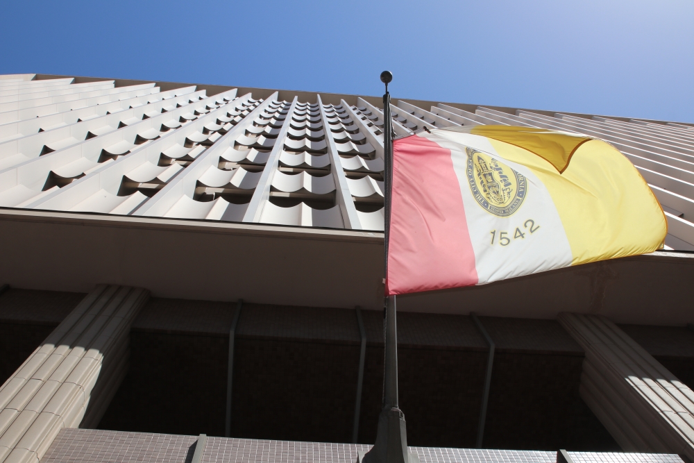 The front of the City Administration Building with the City of San Diego flag in the foreground