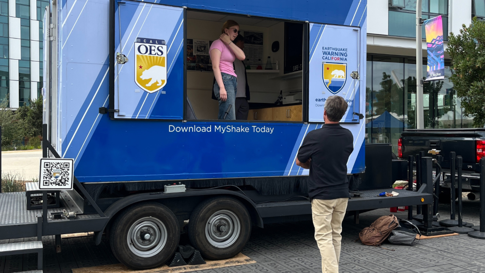 Photo of OES truck with one person standing in front of it