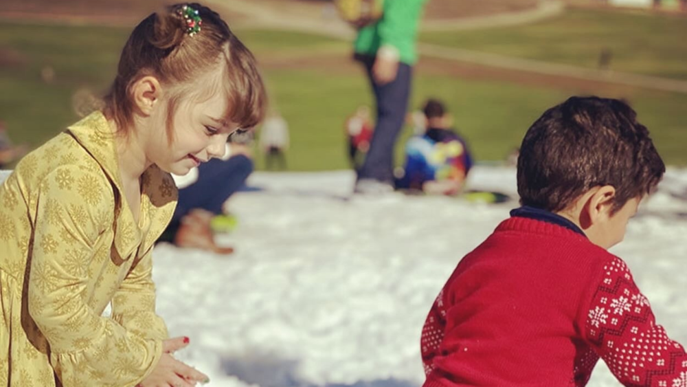 Two children playing in snow