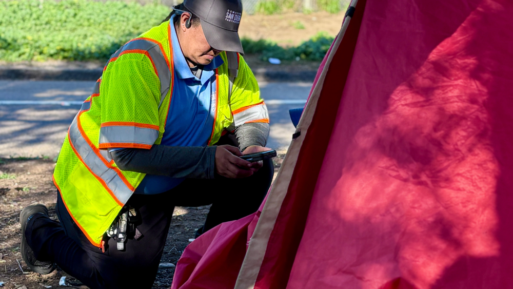 Woman on her knees next to tent