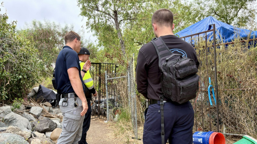 3 employees doing outreach outdoors