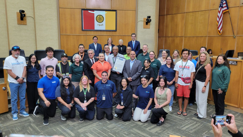 employees with parks and rec dept with city council members inside council chambers 
