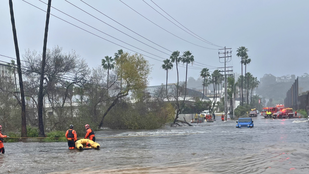 Flooded road and City staff