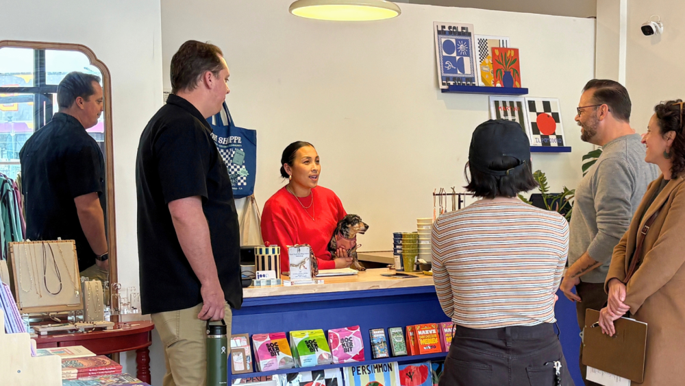 EDD staff talking to a business employee in a colorful setting
