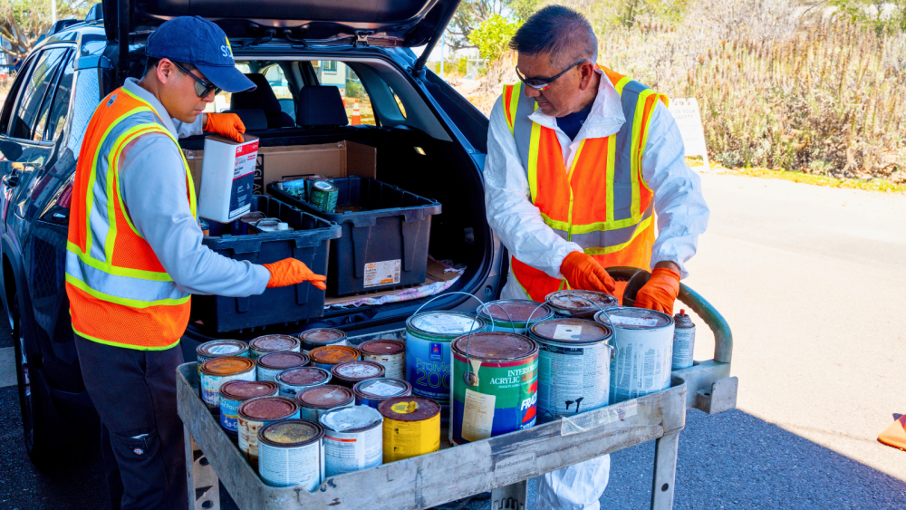 Two ESD staff transferring hazardous waste