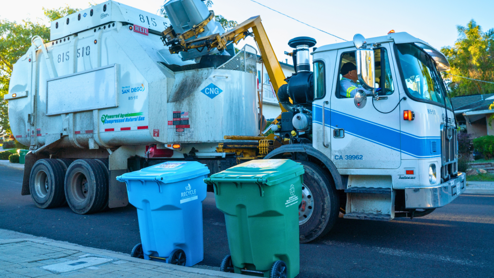 Garbage truck collecting trash