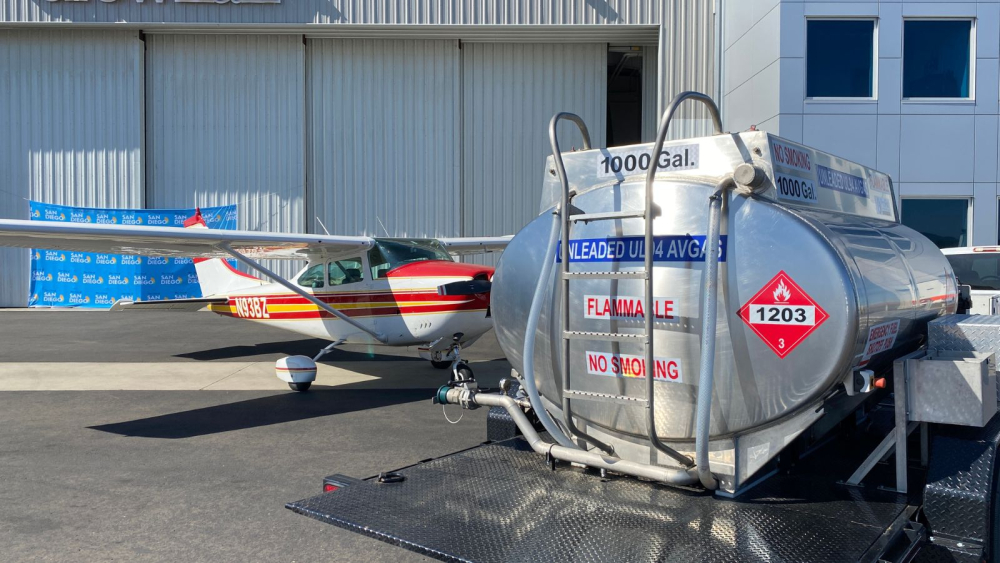 image of airport hanger with small plane and fuel tank