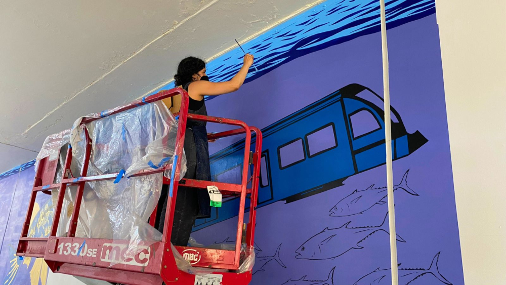 woman painting a mural