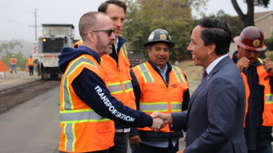 Mayor Gloria shakes City staff's hand