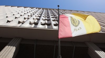 The front of the City Administration Building with the City of San Diego flag in the foreground