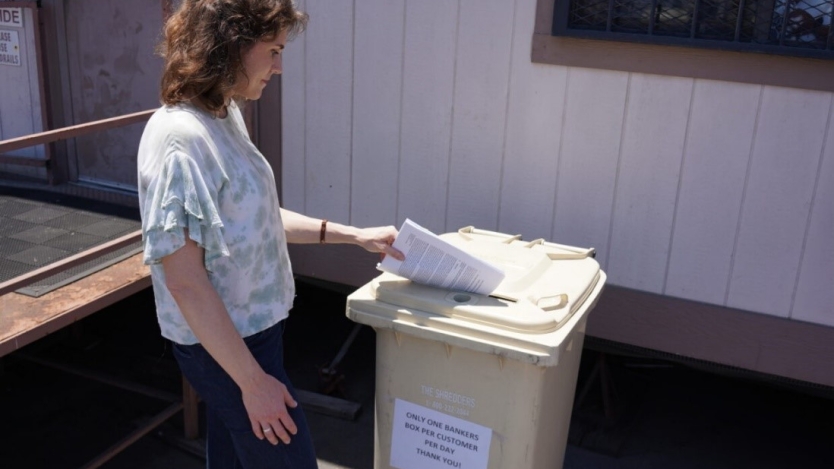 person recycling old tax documents