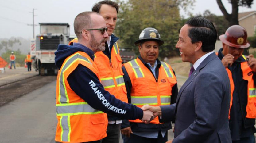 Mayor Gloria shakes City staff's hand