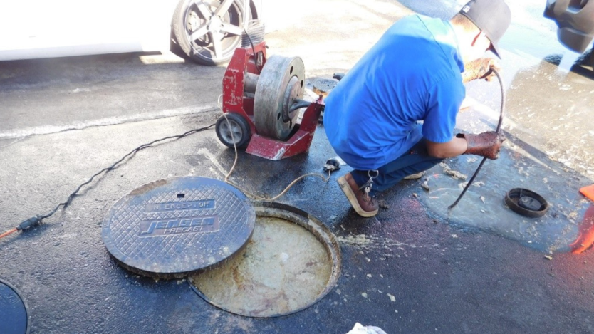 Photo of City staff working on grease blockage