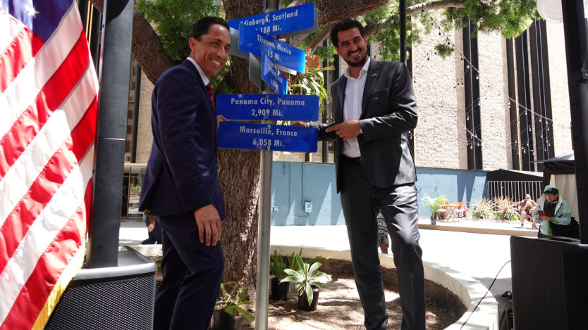 Mayor next to sister cities sign