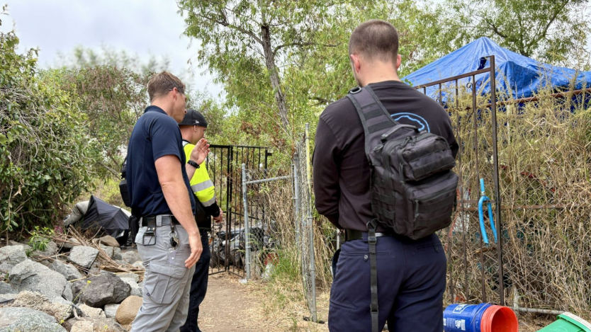 3 employees doing outreach outdoors