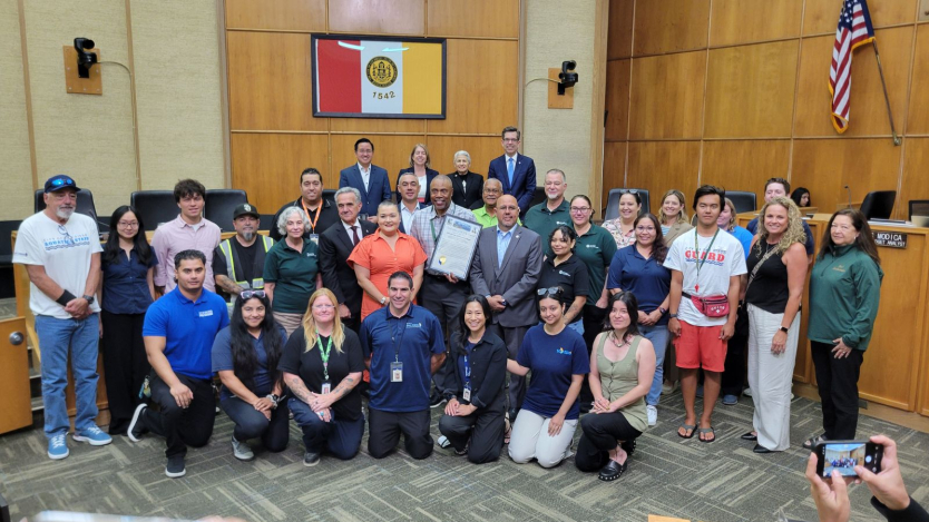 employees with parks and rec dept with city council members inside council chambers 