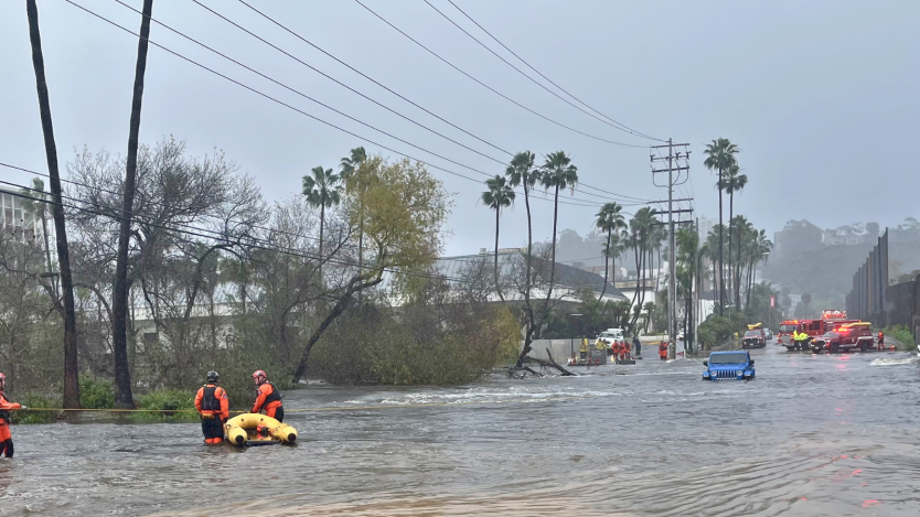 Flooded road and City staff
