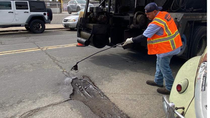 City staff filling pothole