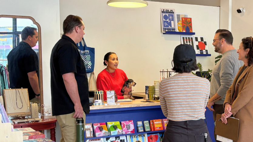 EDD staff talking to a business employee in a colorful setting