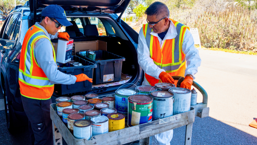 Two ESD staff transferring hazardous waste