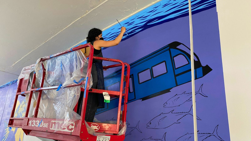 woman painting a mural